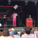 JezO on stage performing with a giant inflatable wand